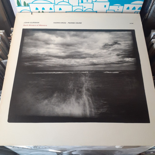 Album cover features a black and white photograph of an ocean and a stormy sky, seen through mist.