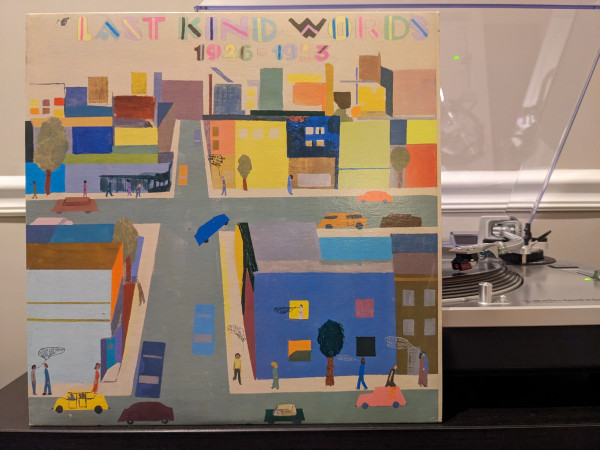 Now playing on LP: Last Kind Words, 1926-1953, a compilation by Mississippi Records. Album cover w/ colorful cityscape artwork. 
