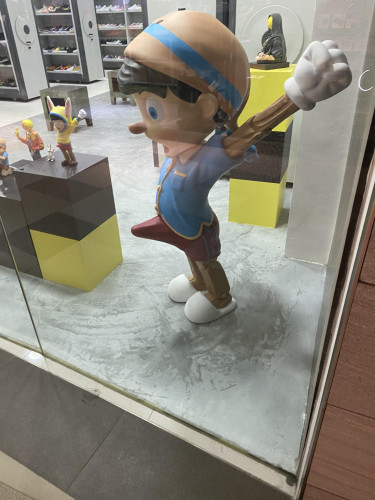 A statue in a shoe store of Pinocchio with an erection