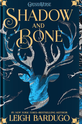 Picture of the book cover of Shadow and Bone by Leigh Bardugo. The book cover is predominantly a deep blue color with the outline of a white stag's head in the middle of it. At the top in gold text is the book's title, Shadow and Bone. Above that in smaller blue print it says "Grishaverse."

At the bottom of the cover in gold text the authors name is printed.