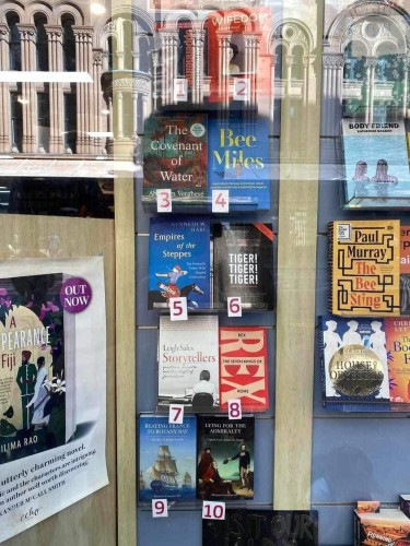 Picture of books on display in the window of a bookstore. ‘Rex: The Seven Kings of Rome’ is at number 8!