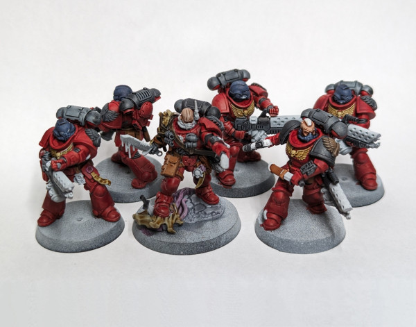 Warhammer 40k Space Marine Infernus squad of five Marines plus a lieutenant painted as Blood Angels. All the colors blocked in, with red armor, black details, and brown leather.