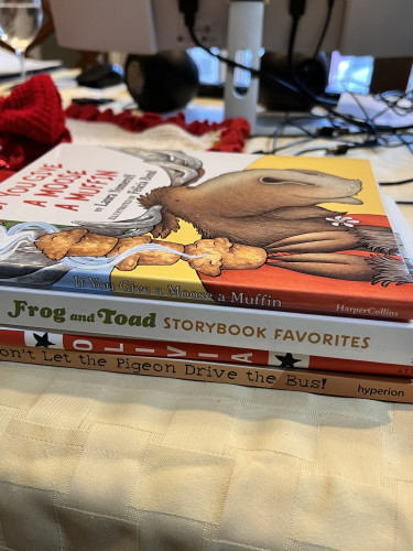 Stack of children’s picture books in hardcover: If You Give a Moose a Muffin by Laura Numeroff, Don’t Let the Pigeon Drive the Bus By Mo Willems, Frog and Toad Storybook Favorites by Arnold Lobel, and Olivia by Ian Falconer.