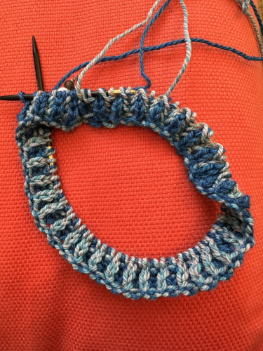 Pics of round knitting on circ needle. Top shows solid blue color dominating side of brioche stitch fabric, bottom shows light blue dominating side of brioche stitch fabric