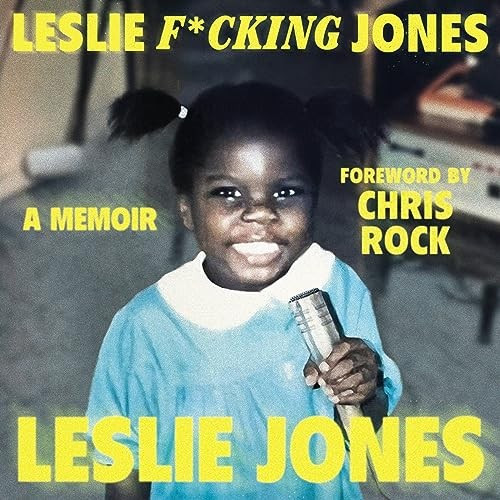 Cover image is an old photo of little Leslie Jones in pigtails and a blue dress with a white color holding a microphone (?) some mic-like object and grinning the grin that is uniquely hers. Text says "Leslie F*cking Jones a Memoir Foreward by Chris Rock Leslie Jones."
