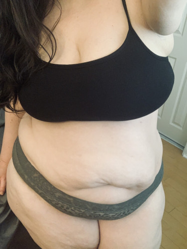 Just my body (no face). I'm wearing a black bralet and some olive green lace panties. My cute fat tummy is soft and kissable. 