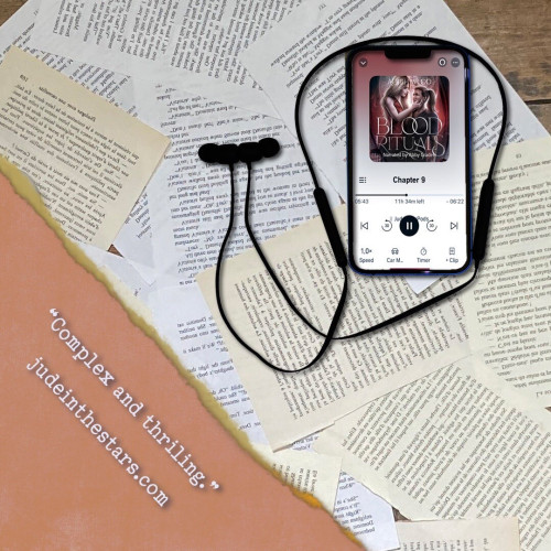 On a backdrop of book pages, an iPhone with the cover of Blood Rituals (Boston Preternatural Investigations Unit, Book 1) by Aoibh Wood, narrated by Abby Craden. In the bottom left corner of the image, a strip of torn paper with a quote: "Complex and thrilling." and a URL: judeinthestars.com.