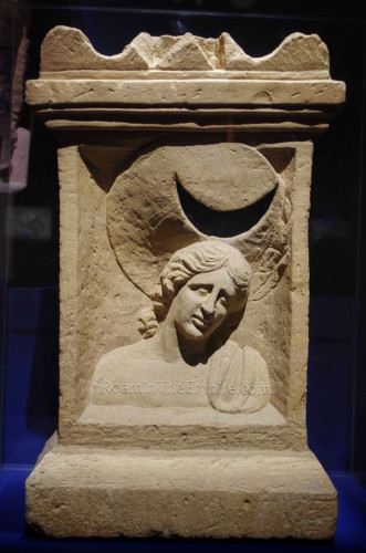 Stone altar with a relief of Luna carved into it. She is wearing the lunar horns or lunar crescent on her hear, an aureola implied. It most likely used to be painted.