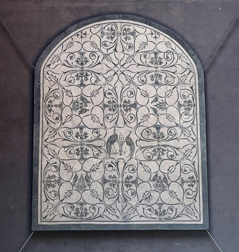 A black and white mosaic with two peacocks in the centre and what looks to be partridges with figs throughout.