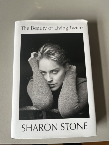Cover of  The Beauty of Living Twice by Sharon Stone. Photo is a monochrome photo of her.
