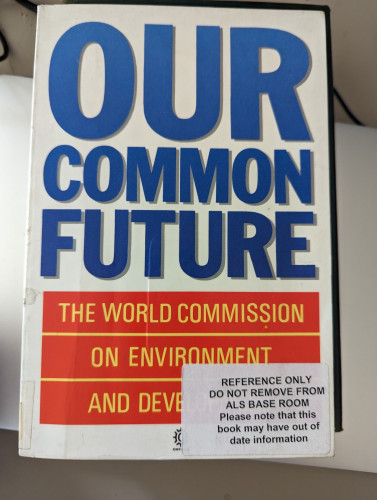 A former library copy of 'Our Common Future's, a report by The World Commission on Environment and Development, with a sticker on the front that reads "REFERENCE ONLY. DO NOT REMOVE FROM ALS BASE ROOM. Please note that this book may have out of date information"
