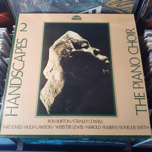 Album cover features a photo of a rock, into which the face of an African man has been carved.