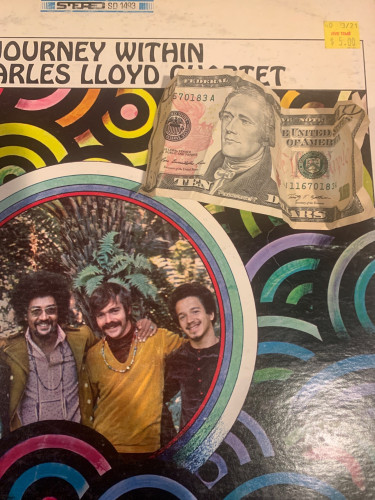 Charles Lloyd Journey Within with $5.00 price sticker on it with a crumpled $10 bill on top. 