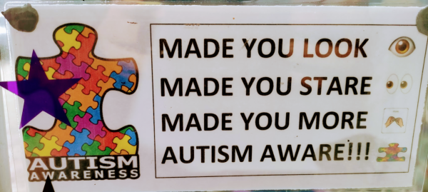 A poster that says:
MADE YOU LOOK
MADE YOU STARE
MADE YOU MORE
AUTISM AWARE
next this this is a puzzle piece line drawing. Inside that, there are several more puzzle pieces. Underneath that, it says "Autism Awareness"