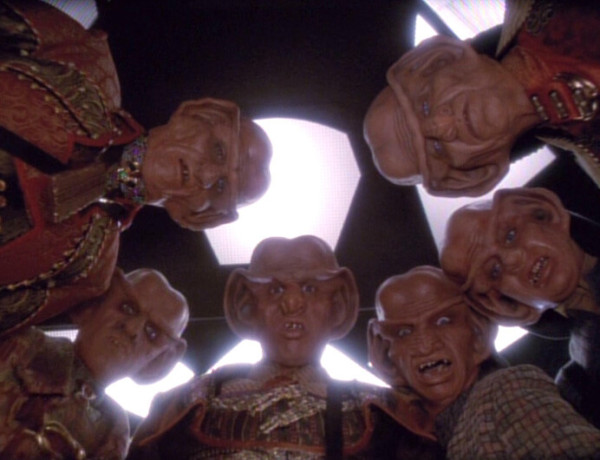 Quark and fellow Ferengi hovering over a dead body. 