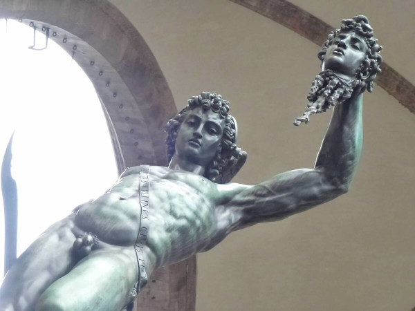 An amazing shot of Cellini's Perseus that looks as if he is looking directly at the viewer. He holds his sickle sword in his right, raising in his left the severed head of Medusa.
The sculpture is made of bronze and stands in Florence, Italy.