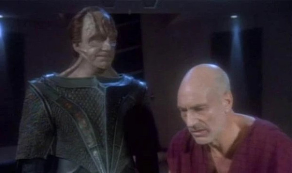 Screenshot from Star Trek TNG episode “Chain of Command Part 2” with David Warner as Gul Madred & Patrick Stewart as Jean Luc Picard. Gul Madred is standing over Picard, who appears exhausted & defeated.