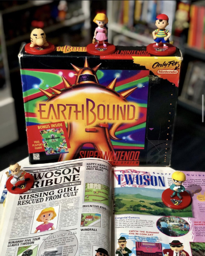 The Earthbound strategy guide with a CIB Earthbound and a bunch of Earthbound figures. 