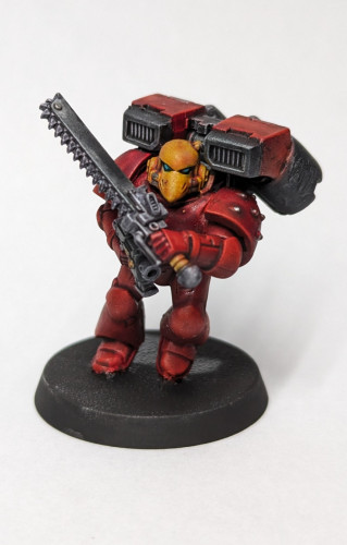 Warhammer 40k Space Marines Assault Marine with a jump pack, bolt pistol, and chainsword. Painted up in a Blood Angels color scheme.