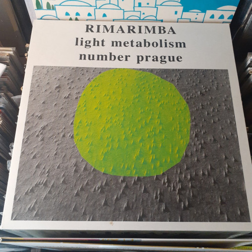 Album cover features an abstract design.  It's a large light green dot superimposed over a textured surface.