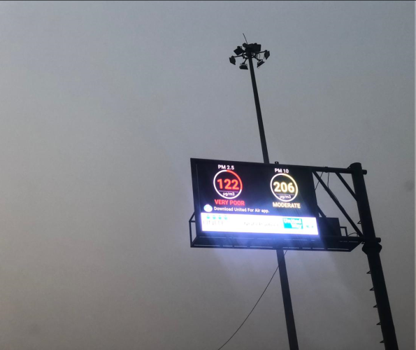 A singage displaying the air quality in the city of Gurgaon, India. One reads 122 microgram per cubic meter, is red in color, and with a Very Poor text. Another one (yellow in color) reads 206 microgram per cubic meter with the text Moderate written below it. 