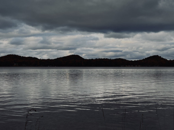 Gray clouds reflected on a lake forebodes the coming of winter weather.