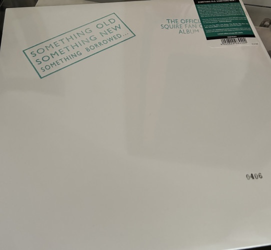 Front cover of the official fan club album from Squire. Minimalistic, white with a stamp reading ‘something old, something new, something borrowed’ also stamped number 406. 