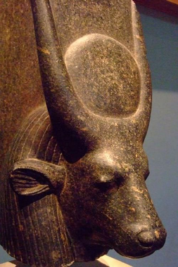 Photograph of an ancient Egyptian sculpture of Hathor with a cow's head and a solar disk between her horns.