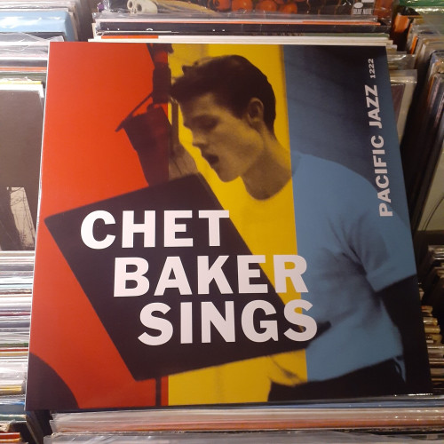 Album cover features a striking red, yellow, and blue tinted photograph of Chet Baker singing in the studio.