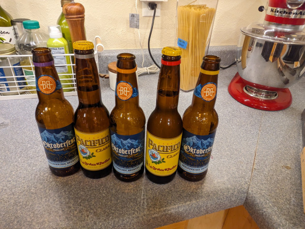 Photo of five beers with five different colors of rings around their necks