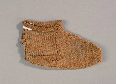 The picture shows a brown beige infant's sock