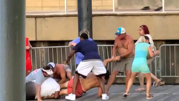people dressed casually fighting on a dock