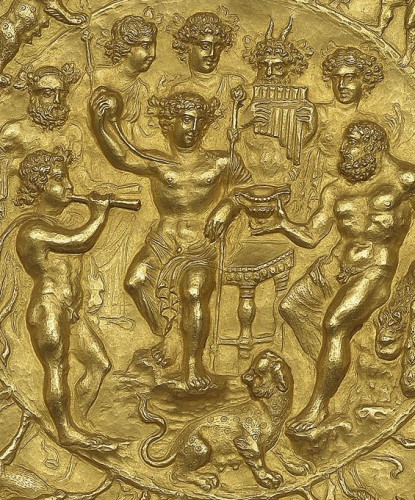 Engraving of the drinking contest between Dionysos and Herakles. They are surrounded by Bacchic onlookers. A female panther with swollen teats sits to the wine god's feet, visualising his fertility powers. Dionysos smiles as he holds up his upturned cup while Herakles is still drinkng signalling his victory.