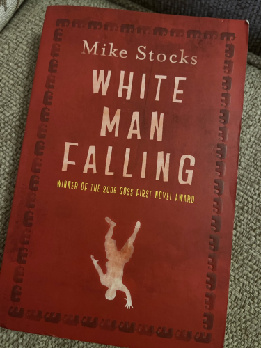 Front cover of White Man Falling featuring a silhouette of a man all in white falling upside down.