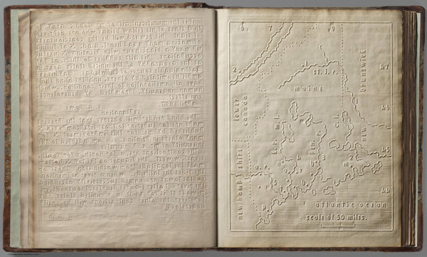 A book opened to show an embossed map and raised text