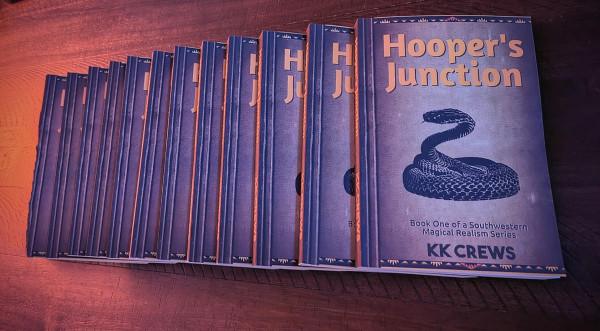A spread out stack of 12 copies of the book Hooper's Junction.