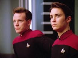 Nick Locarno and Wesley Crusher sitting together and looking serious 