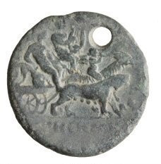 Silver coin depicting Dionysos sitting in his biga chariot, holding his thyrsos, with Apollon Kitharoidos seated beside him. The biga is drawn by a panther and a goat on which Silenos sits playing the double flute.