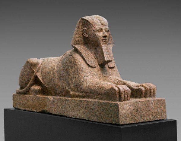 Description from museum: “This colossal sphinx portrays the female pharaoh Hatshepsut with the body of a lion and a human head wearing a nemes–headcloth and false beard. The sculptor has carefully observed the powerful muscles of the lion as contrasted to the handsome, idealized face of the pharaoh. It was one of at least six granite sphinxes that stood in Hatshepsut's mortuary temple at Deir el-Bahri.”