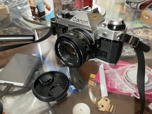 A Canon AE-1 Program camera with a 50mm lens