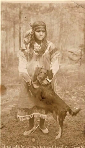 Native American girl with her dog. circa 1920, Penobscot Indian Reservation, Maine.