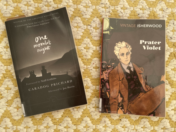 Photo of two books on a yellow background. One Moonlit Night by Caradog Prichard with a moody black &white pic of rooftops and mountains on the cover. Prater Violet by Christopher Isherwood with a pic of a foppish young man on the cover