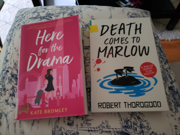 2 books on cushion. Here for the Drama by Kate Bromley and Death Comes to Marlow by Robert Thorogood.