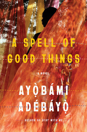 Book cover of Ayobami Adebayo's second novel A Spell of Good Things, reflecting a treed and scrubby brush landscape in the background with long yellow and red draped fabric pieces, gauzy and partially see-through in the foreground, stretching to the ground, past a human figure that's mostly shadowed but their darkened profile and body somewhat visible.