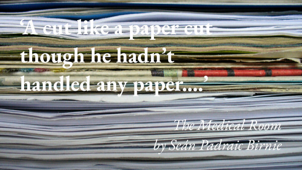 A stack of paper, with a quote from Seán Padraic Birnie's short story The Medical Room: 'A cut like a paper cut though he hadn’t handled any paper…'
