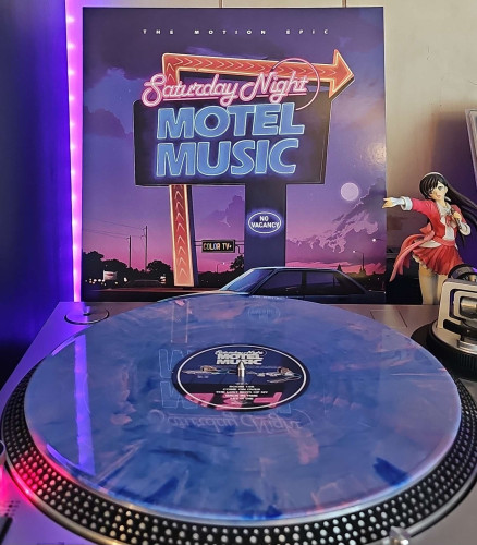 A Blue & Pink Marbled vinyl record sits on a turntable. Behind the turntable, a vinyl album outer sleeve is displayed. The front cover shows a motel sign that says "Saturday Night Motel Music", as well as "No Vacancy" and "Color TV". A car sits underneath it. . 

To the right of the album cover is an anime figure of Yuki Morikawa singing in to a microphone and holding her arm out. 