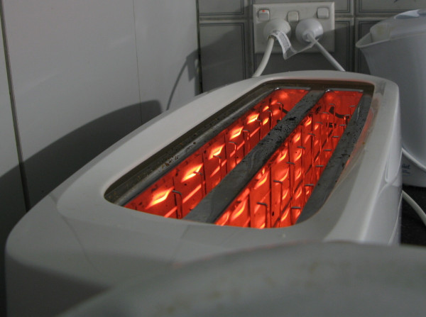 A toaster with glowing red filaments.