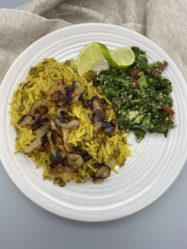 Plate with mjeddra with caramelized onions and tabbouli 