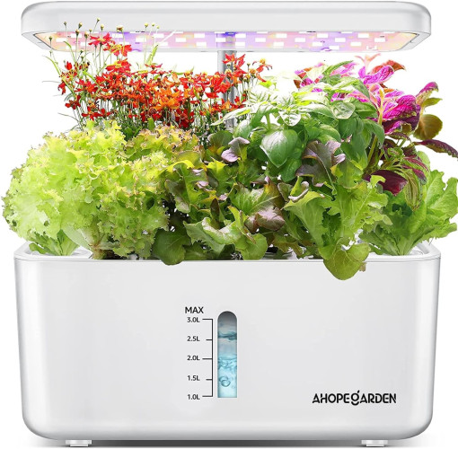 An indoor planter: a white rectangular tub with a water level indicator, labeled "Ahope Garden", overflowing with a bounty of healthful plants, with grow lights alove them held up by pole from the back of the tub.