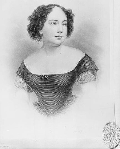 A black and white etching of Anna Ella Carrol. She is shown from the waist up, looking wistfully off to the viewer's left. Sher wears her hair above her shoulders and curly, and is dressed in a dark gown.